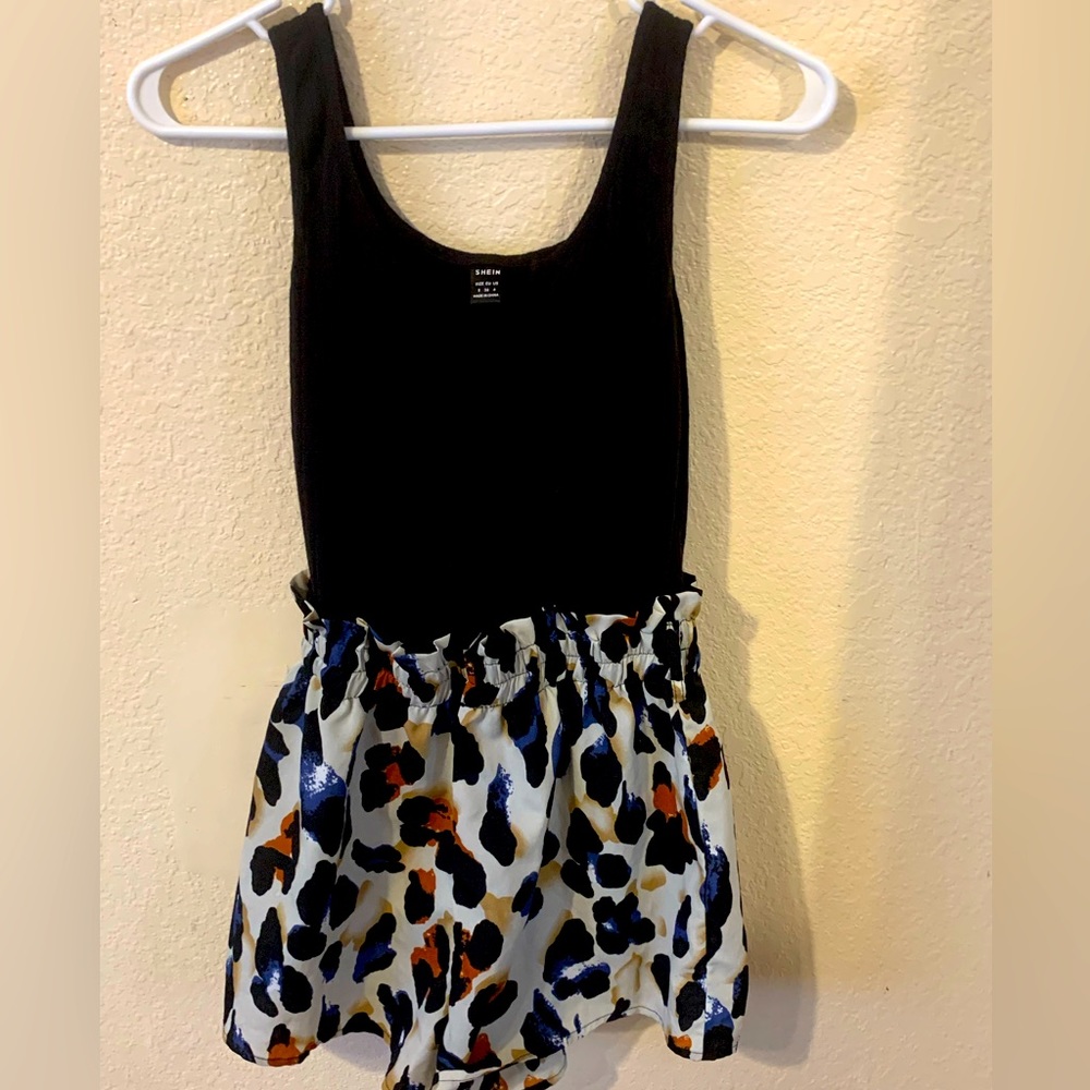 Selling a romper with leopard print at the bottom and black up top